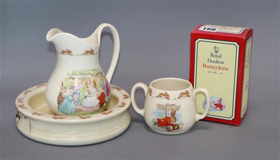 A Bunnykins bowl jug and two handled mug together with twelve Bunnykins characters including: Clean Sweep, Sun Dial, The Easter Parade